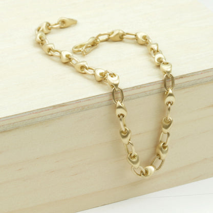Pebble Chain Bracelet, draped on wood