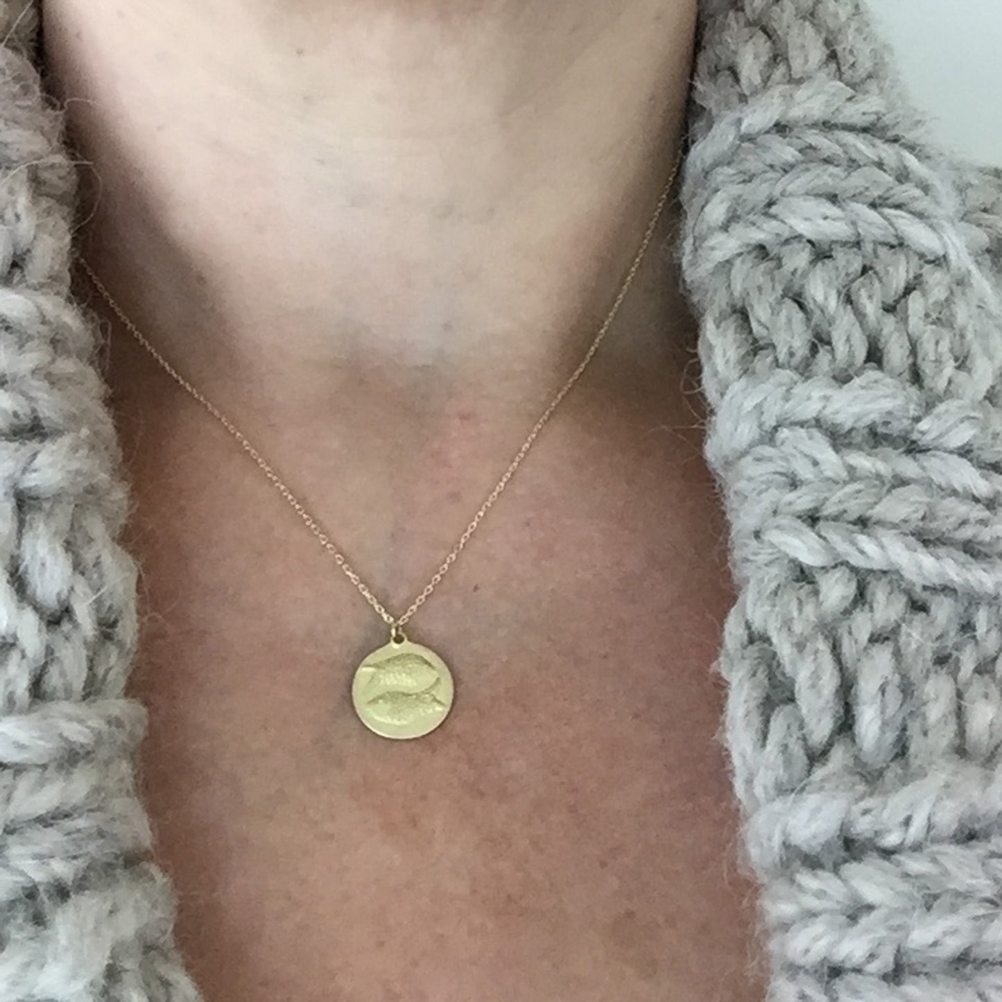 Pisces Medal on neck