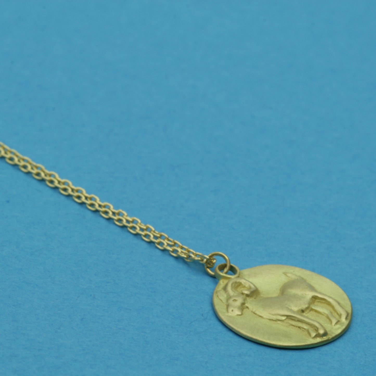 Aries Medal, side view on blue background