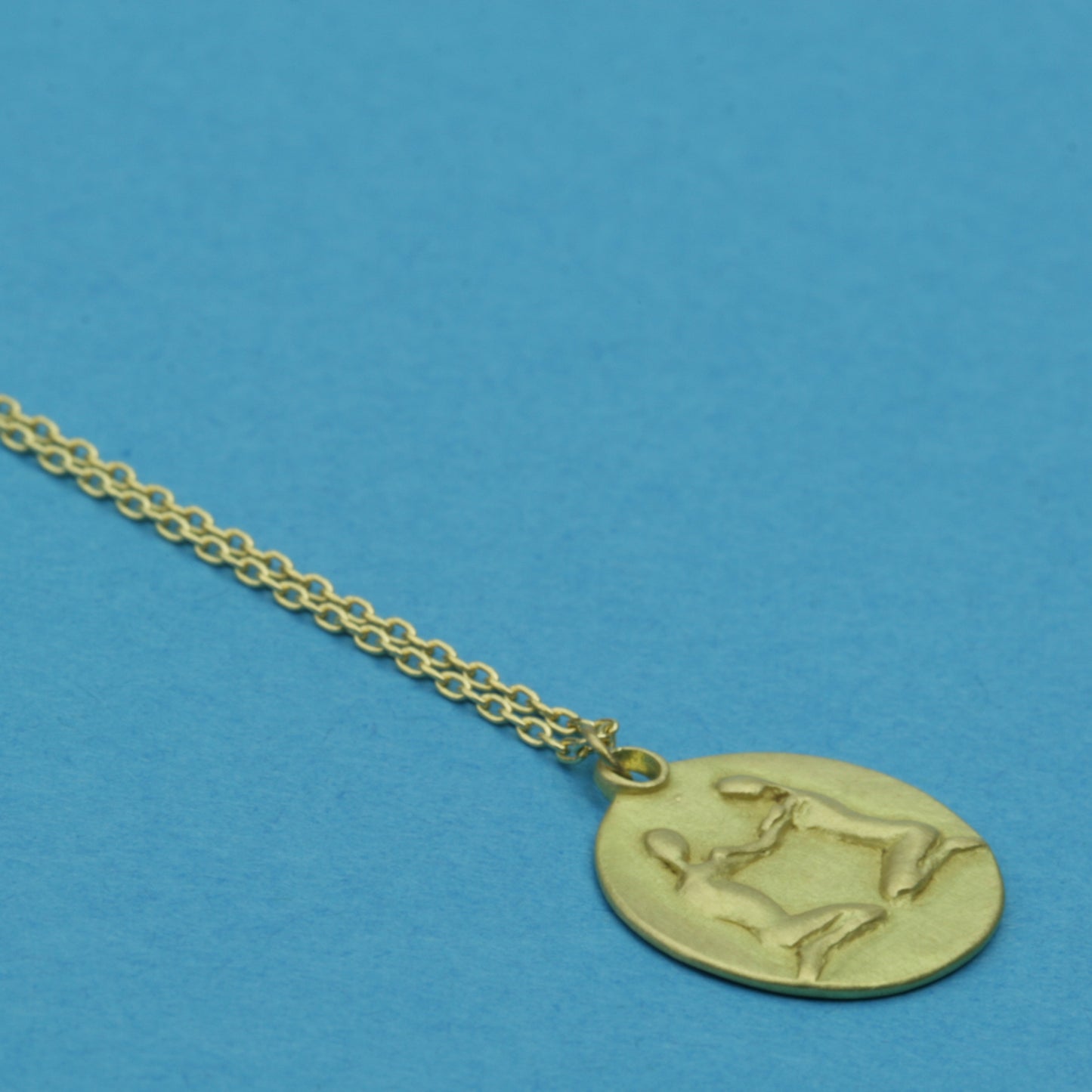 Gemini Medal on cable chain, side view
