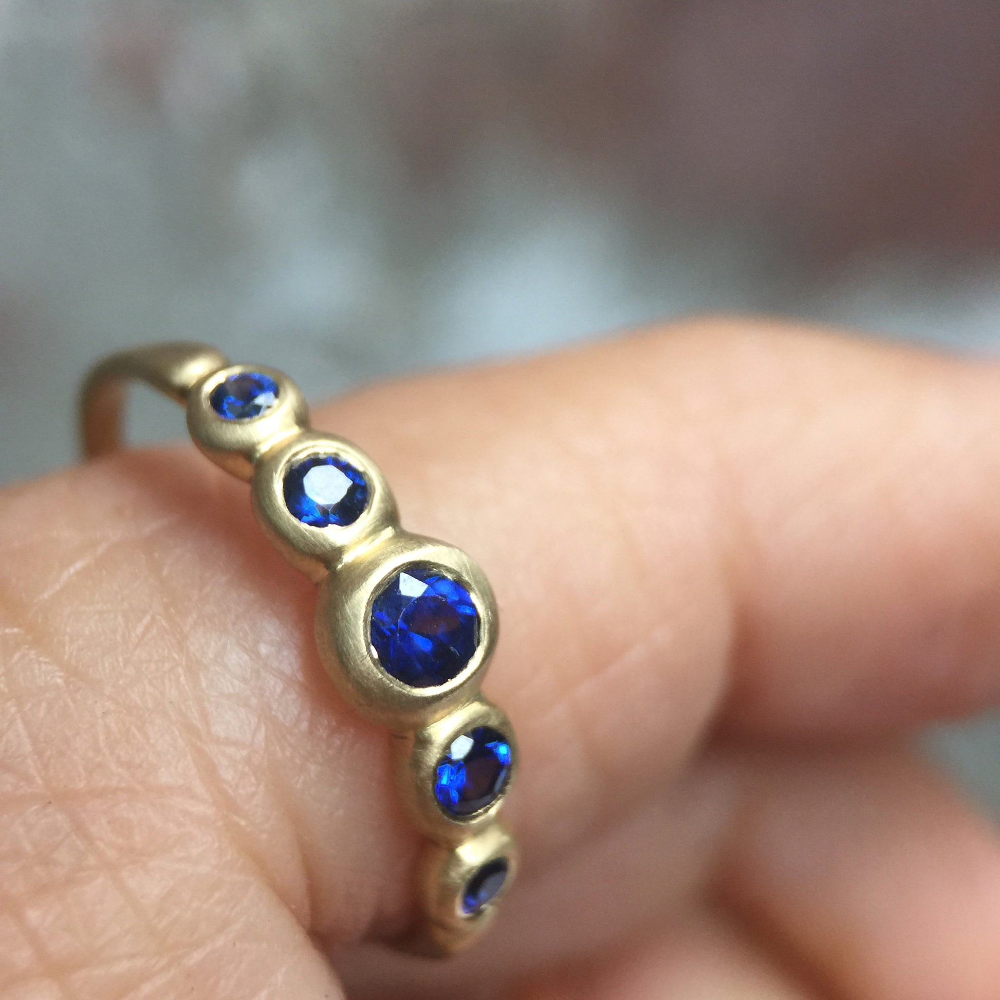 Kima Ring with blue sapphires, detail on finger
