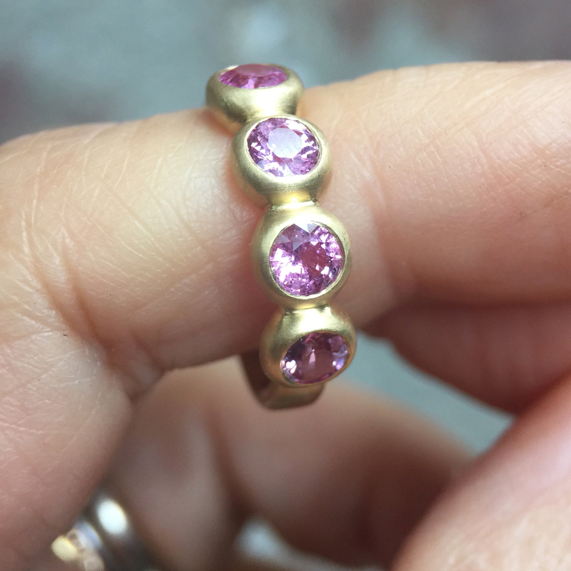 Porch Skimmer Band with 4 mm pink sapphires, detail on finger