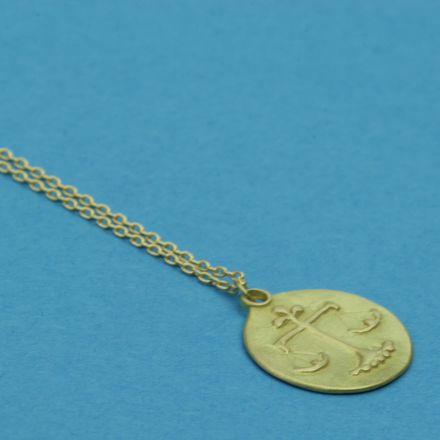 Libra Medal on cable chain, side view
