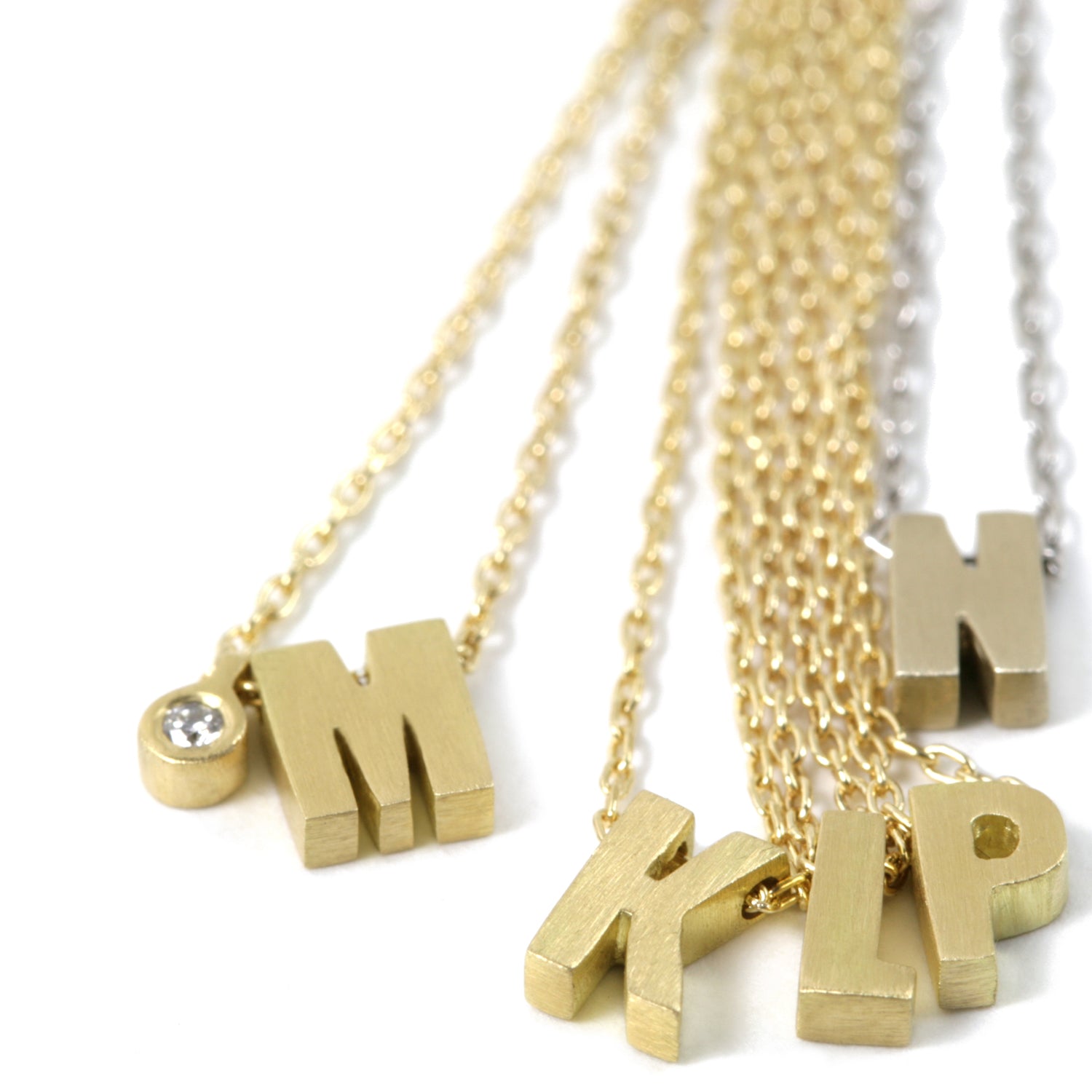 Micro initials, M with diamond tag, K, L, P, N in 18k white gold